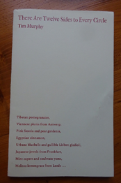 This is a photo of the pamphlet on a brown surface, maybe a desk. It is pale cream in colour. The text on it is all dark pink and left justified. At the very top the title, in lower case with each word except 'to' beginning with a capital: There Are Twelves Sides to Every Circle. Below this, left justified, with author's name, also lower case but slightly smaller. In the bottom third, left justified there are the first eight lines from one of the poems. They begin 'Tibetan pomegranates, / Viennese plums from Antwerp, / Pink freesia and pear gardenia' and so on.